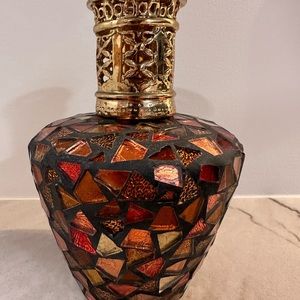 A beautiful glass mosaic Lampe Berger with stone and wick.